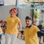 Happy student and parent playing for the yellow team